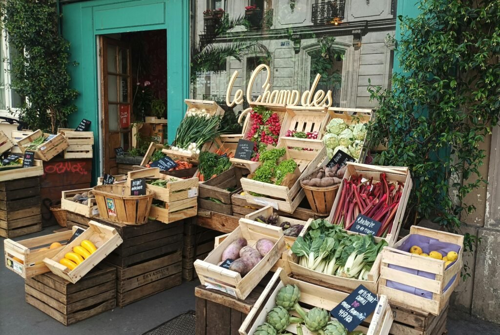 A cozy Paris grocery store with vibrant fresh fruits and vegetables on display outside.