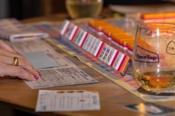 Engaging game night scene with friends playing mahjong and enjoying drinks. Perfect social moment.