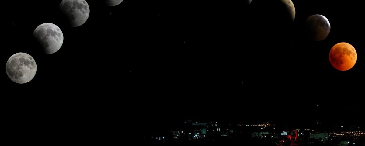 Captivating lunar eclipse sequence featuring blood moon over cityscape.