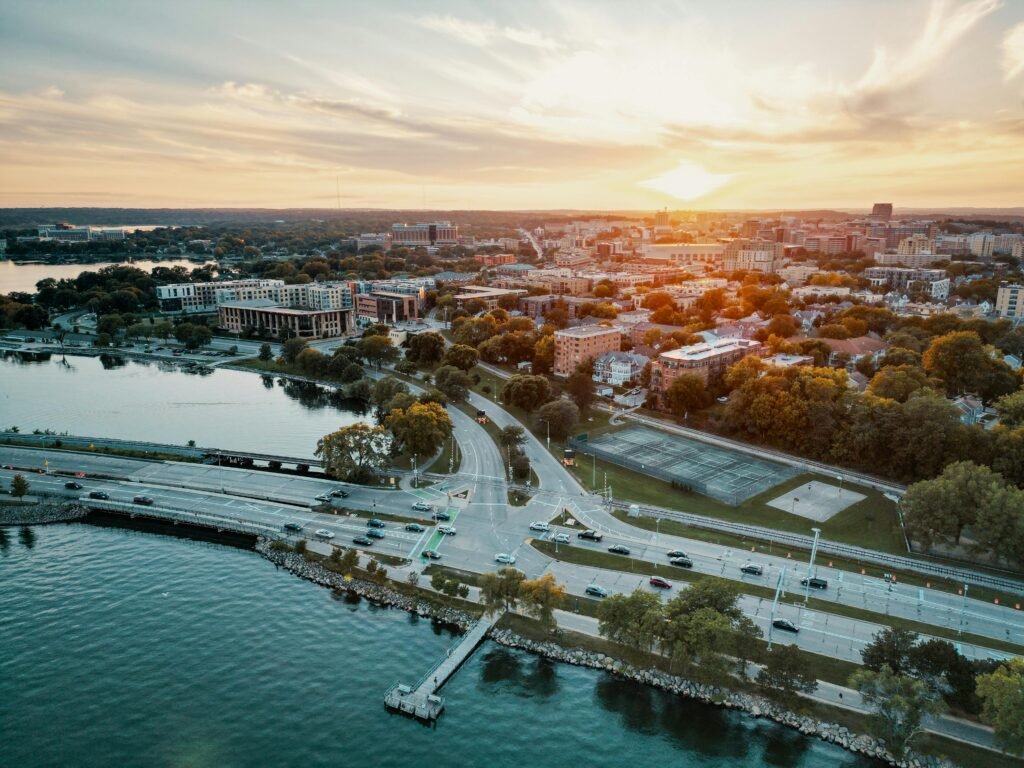 Stunning aerial cityscape of Madison, Wisconsin during sunset with waterfront views.