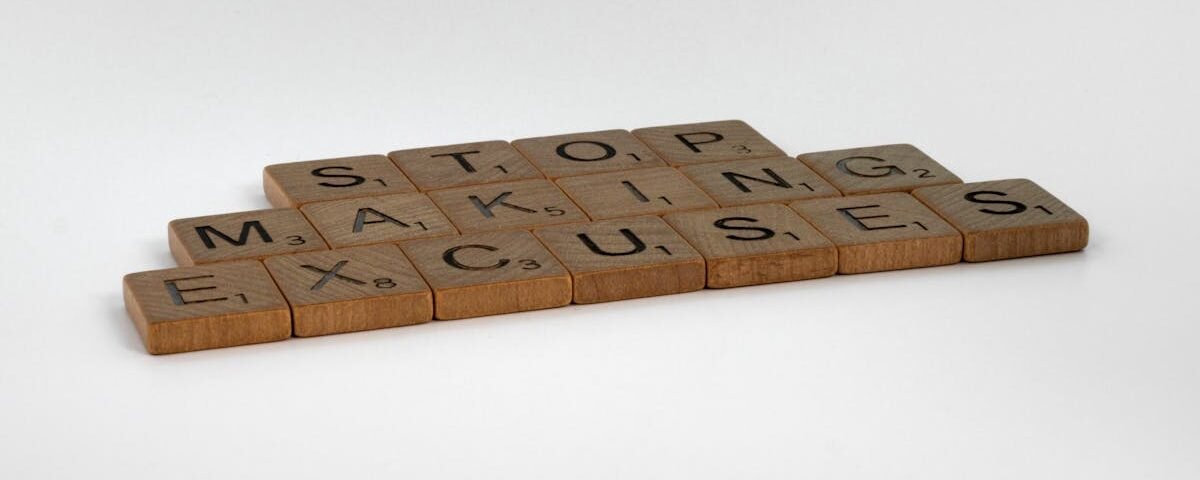 Inspirational phrase "Stop making excuses" crafted with wooden letter tiles.